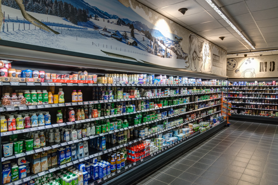 Kempten Molkereiprodukte Langes Kühlregal im Supermarkt mit Milchprodukten und Getränken.